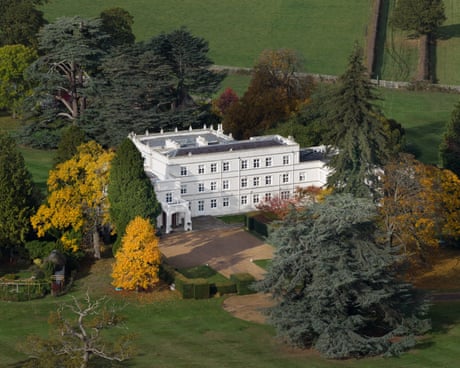 White mansion house surrounded by trees in autumn