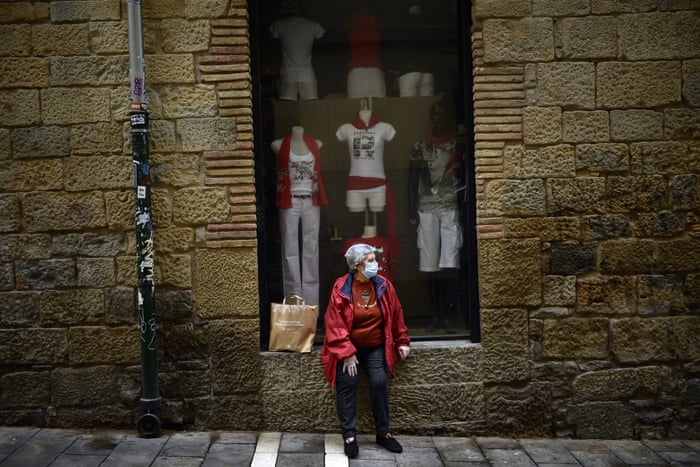 A woman rests in front a shop in Pamplona, northern Spain