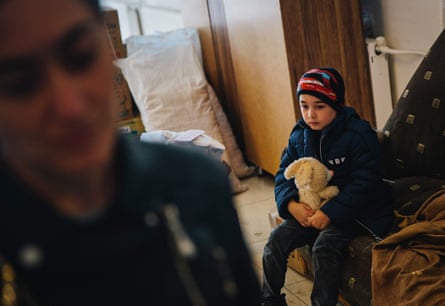 Six-year-old Gor waits inside a distribution centre in the city of Goris