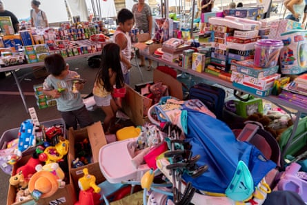 Children check boxes of donated toys at a distribution location in Lahaina on Sunday.