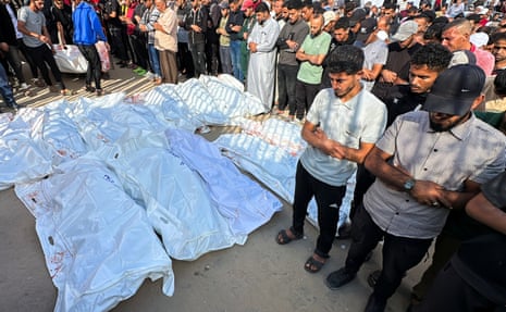Mourners pray at Nasser hospital in Khan Younis during the funeral of Palestinians killed on Tuesday morning.