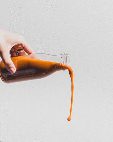 Hot sauce bottle in the middle of pouring.