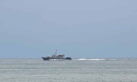 Grey sea and boat in distance