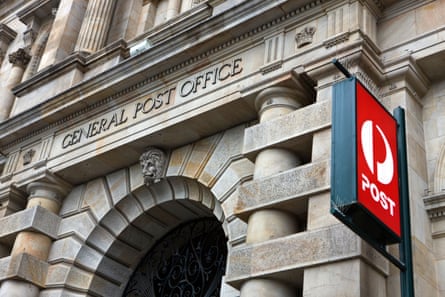 The facade of the General Post Office in Adelaide alongside a more modern Australia Post sign