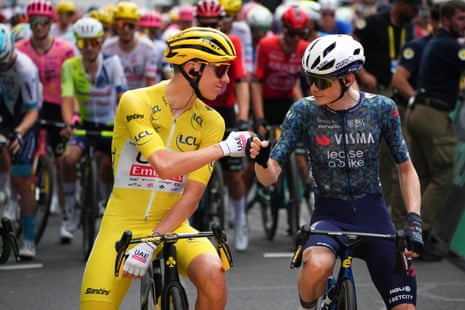Tadej Pogacar, wearing the overall leader's yellow jersey, and onas Vingegaard, pump fists prior to the twelfth stage of the Tour de France 2024.