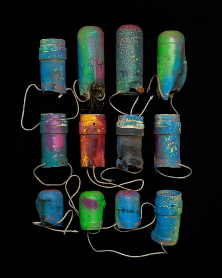 Empty teargas canisters remade into hanging plant pots.