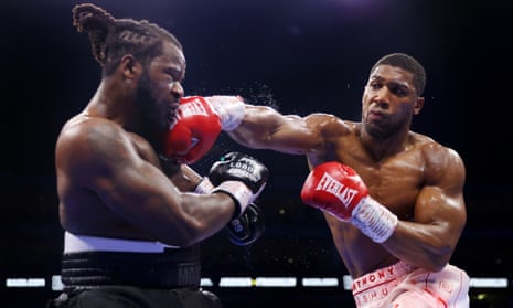 Anthony Joshua (right) unleashes a right-hand on the American Jermaine Franklin during his heavyweight points victory.