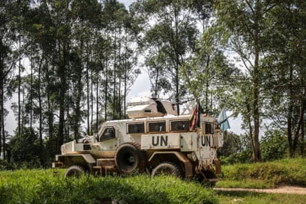 An armoured UN vehicle on a road in a wooded area