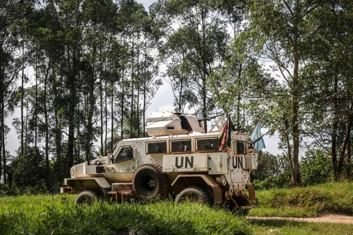 An armoured UN vehicle on a road in a wooded area