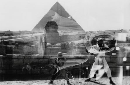 black and white image of people in front of sphinx superimposed on top of pyramid