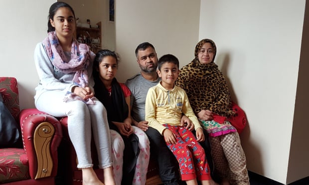 Nazmu Miah and family in their flat in Donald Hunter House, east London.