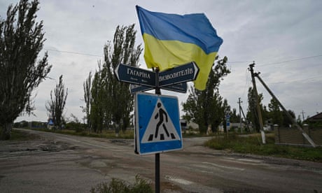 A Ukrainian flag waves on a street of the recently liberated village of Vysokopillya in the Kherson region