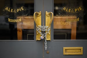 A padlock and chain secures the door of a temporarily-closed pub on 10 February, 2021 in London, England. With a surge of Covid-19 cases fueled partly by a more infectious variant of the virus, British leaders have reimposed nationwide lockdown measures across England through at least mid February.