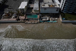 An aerial view shows the damaged pools of two beachfront apartment buildings in the aftermath of Hurricane Nicole at Daytona Beach