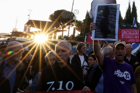 A crowd of people holding signs.