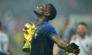 Paul Pogba celebrates with the trophy.