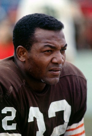 Jim Brown looks on from the sidelines during an NFL game at Cleveland Municipal Stadium circa 1964.