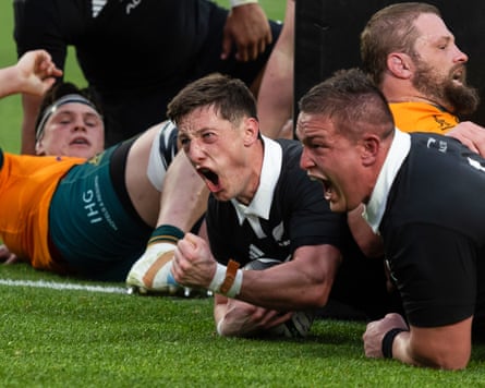 New Zealand's Cam Roigard (centre) roars after scoring a try against the Wallabies