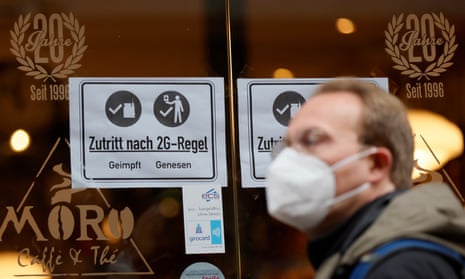 An information sign with ‘Access according to 2G rule: vaccinated, recovered’ is placed on a window at a cafe in the old town of Heidelberg, Germany.