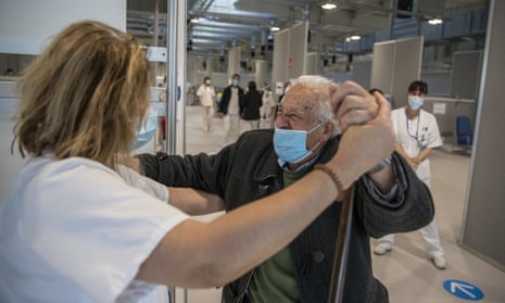 Antonio Garcia, 95, dances with a health worker before being vaccinated with the Moderna vaccine during a Covid-19 vaccination campaign at the Nurse Isabel Zendal Hospital in Madrid, Spain.