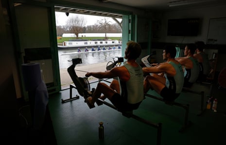 Four members of the men’s squad open up the doors of the Goldie boathouse looking out on the River Cam as they undertake a long session on the ergo machines.