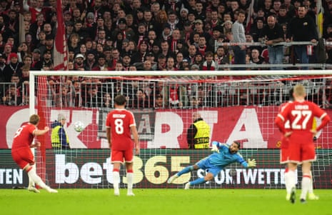 Harry Kane scores a penalty past diving goalkeeper David Raya during a Champions League match