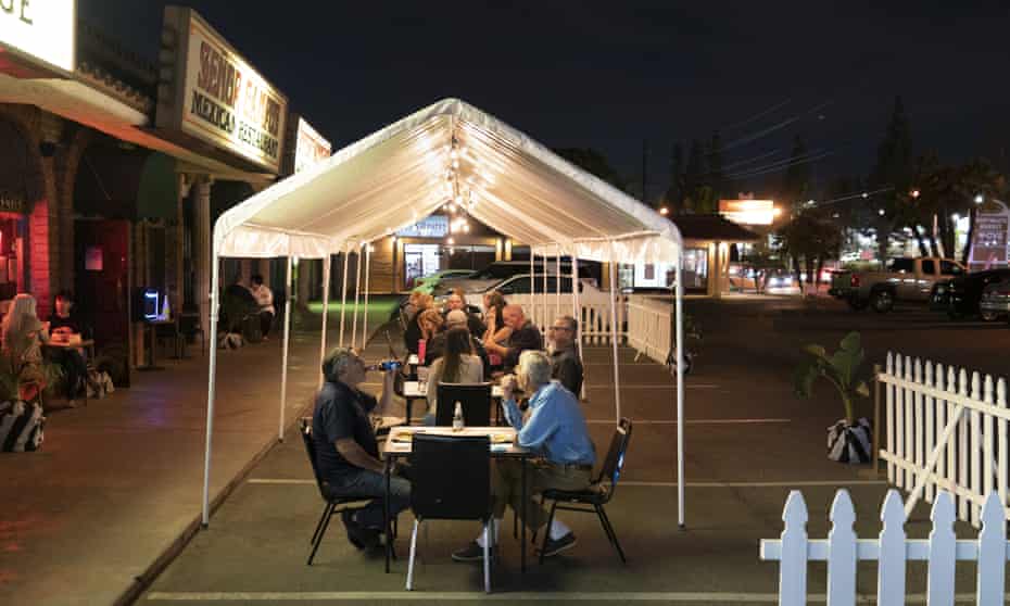 People dine at outdoor accommodations at a restaurant in La Habra, California.