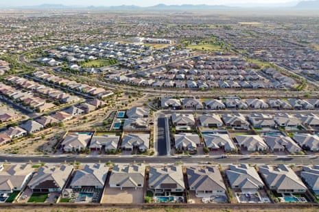 An aerial view of homes  that all look the same, with pointed gray roofs