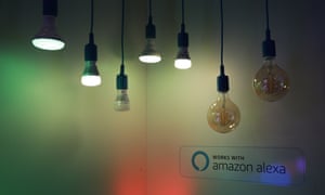 a selection of smart bulbs hanging from flexes in a dimmed space