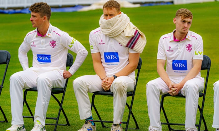 Bartlett wraps a jumper round his face in a pre-season photo call.