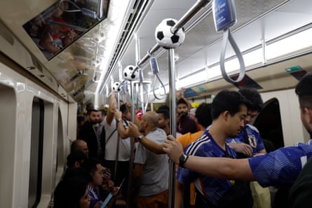 Argentina fans arrive at the Lusail metro stop before their group game against Saudi Arabia;  Japan fans heading on the metro to their game against Spain at Khalifa International Stadium.