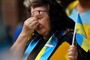 A protester is seen crying during a rally at Martin Place in Sydney, Australia