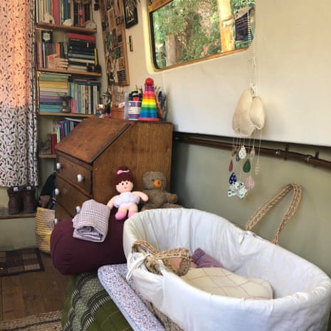 The interior of Faye Keegan's narrowboat, showing her baby's cot