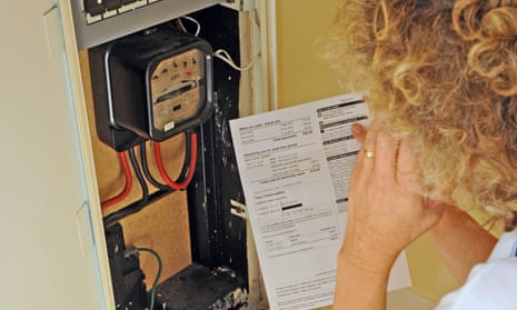 A woman looking at a domestic electricity meter