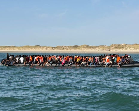 A large dinghy carrying many people near a beach.