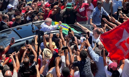 Brazil's former president and presidential candidate Luiz Inacio Lula da Silva greets supporters after casting his vote.
