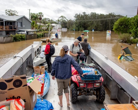 People on a boat in flood waters in NSW