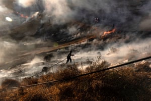 Nicosia, Cyprus: A firefighter douses flames in an effort to contain the island’s worst fire in decades.