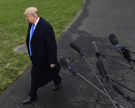 Trump walks in front of microphones.