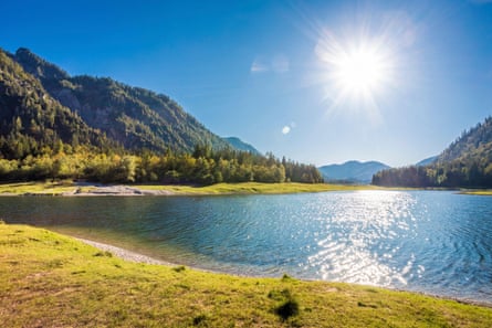 Lake, setting sun, green hills