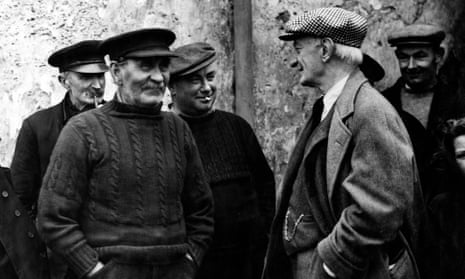 William Beveridge, smiling, in a group of men wearing jumpers