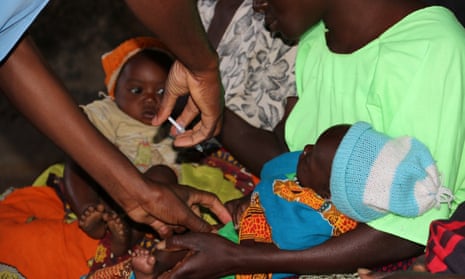 Brian Chimpuku administers the malaria vaccine to a five-month old child in Mkaka, Malawi