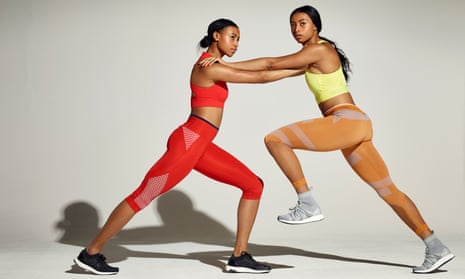 Shannon and Cheriece Hylton in athletics kit, a profile view of them pushing into each other's shoulders, their long legs in a stride
