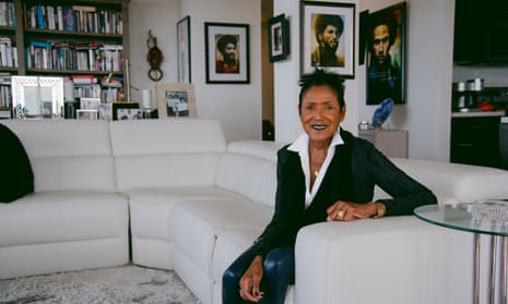 Elaine Brown at home in Oakland. Behind her, portraits of (from left) Bobby Seale, John Huggins and Huey Newton.