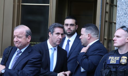 Michael Cohen, second left, leaves court in New York.