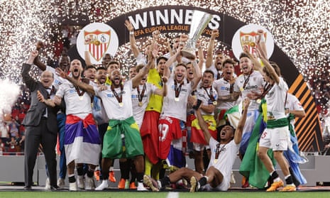 Sevilla’s Ivan Rakitic lifts the trophy after the victory on penalties over Roma
