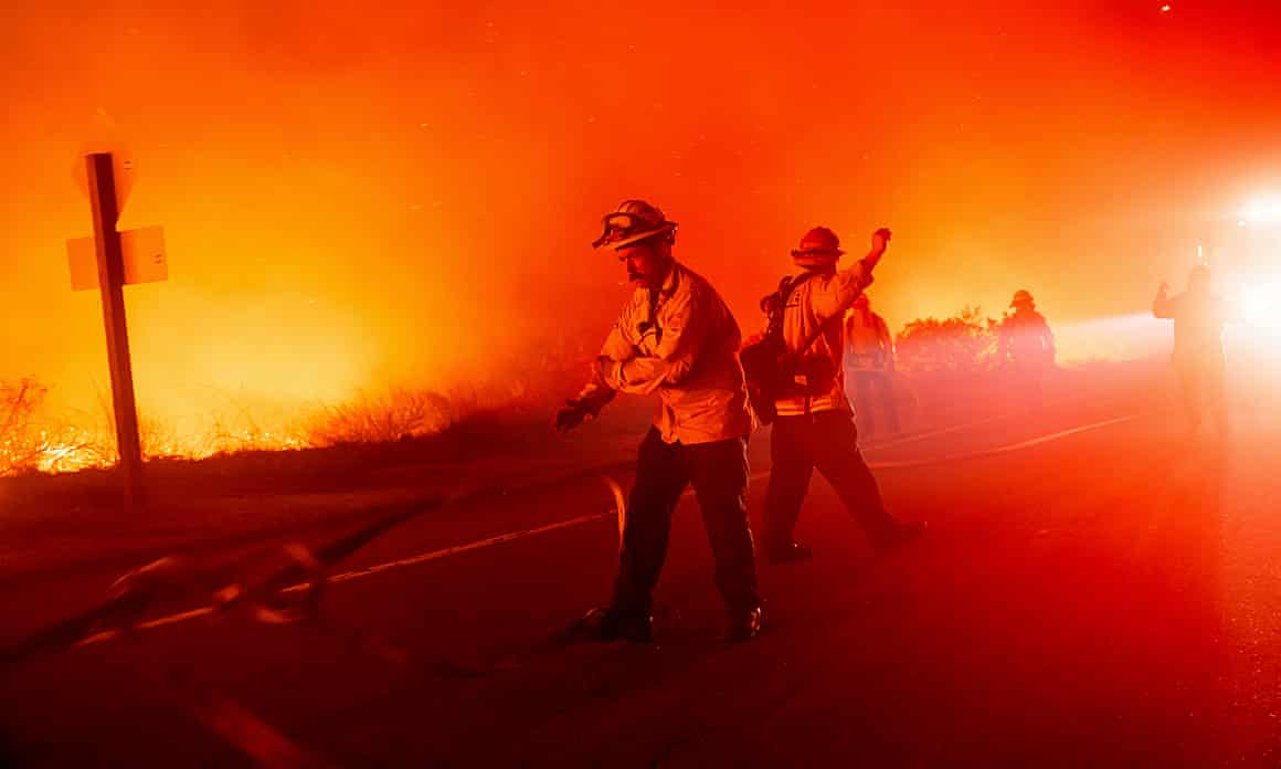 Firefighters battle the Lilac fire near the Bonsall community of San Diego county, California