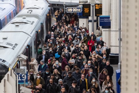 Commuters arrive at London Waterloo station during a morning rush hour.