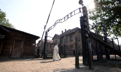 Pope Francis walks through the gate of Auschwitz on Friday.