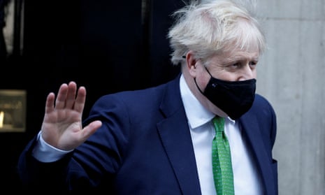 Boris Johnson waves as he leaves Downing Street, in London, on 19 January.